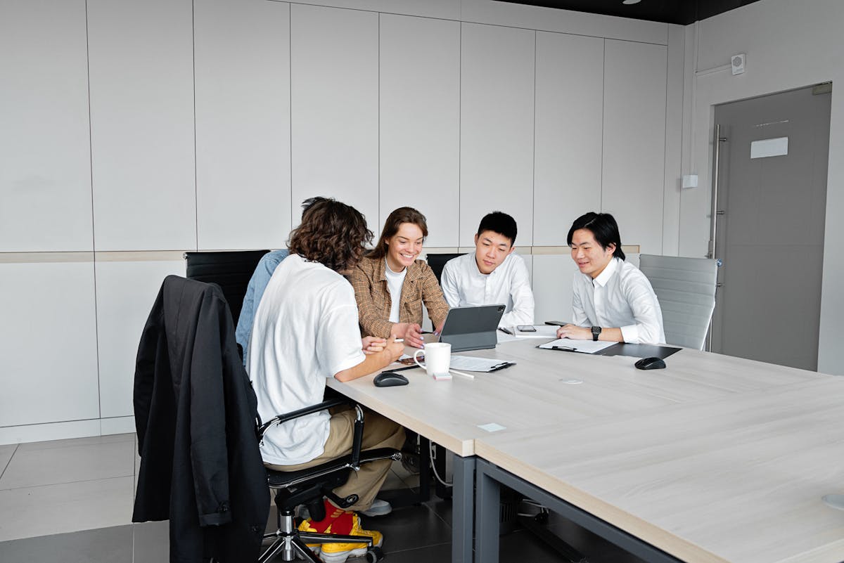 Team collaborating in a modern office, representing mobile QA planning on remote Mac hosts